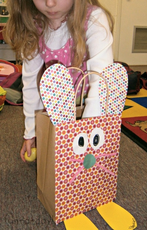 preschooler putting easter eggs in a DIY bunny bag