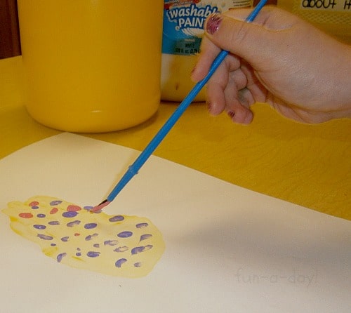 preschooler decorating their easter egg handprint craft
