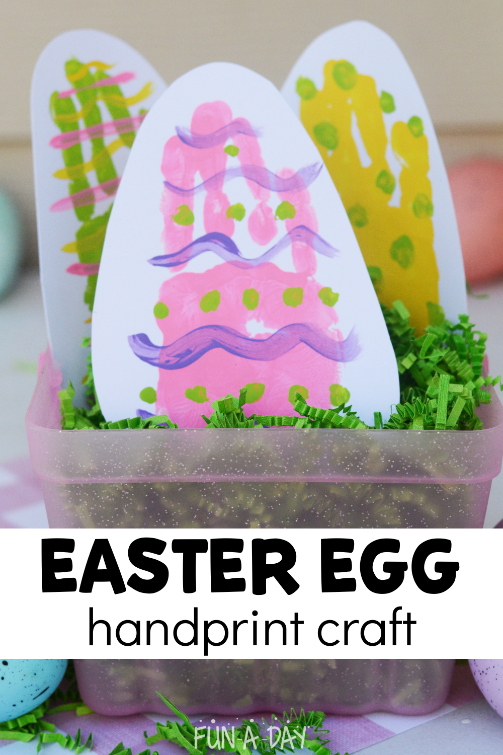 3 child-made hand print eggs in a basket with text that reads easter egg handprint craft