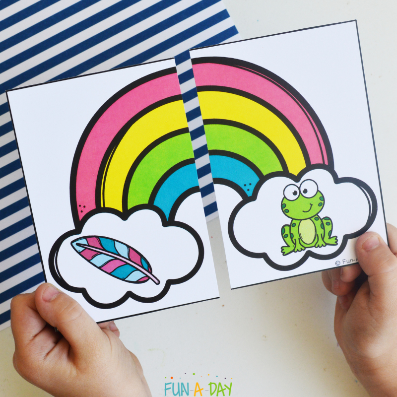 child matching feather and frog pieces of rainbow literacy puzzle