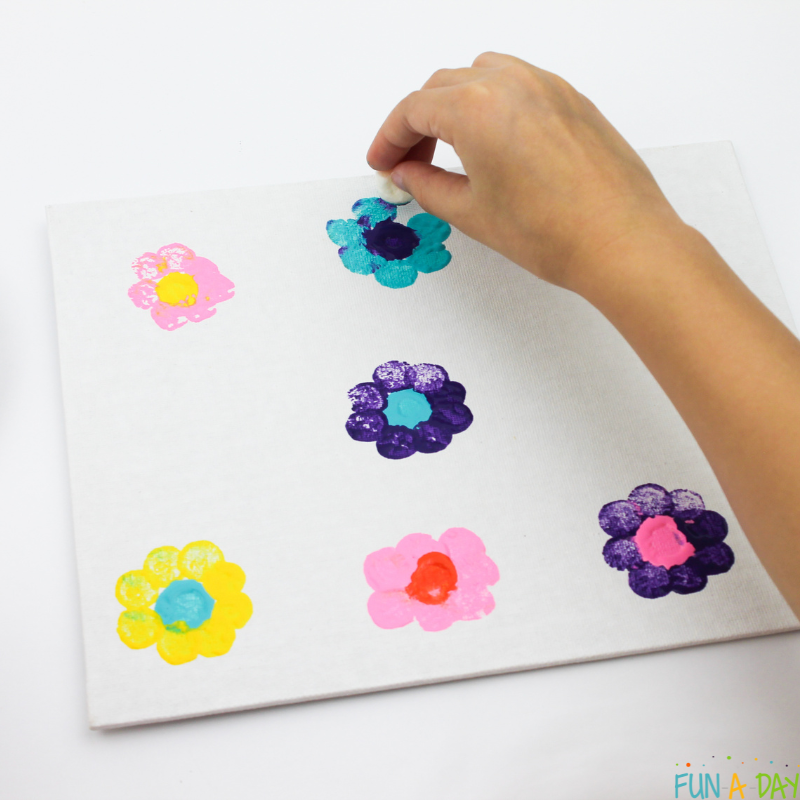 child painting flowers with marshmallows