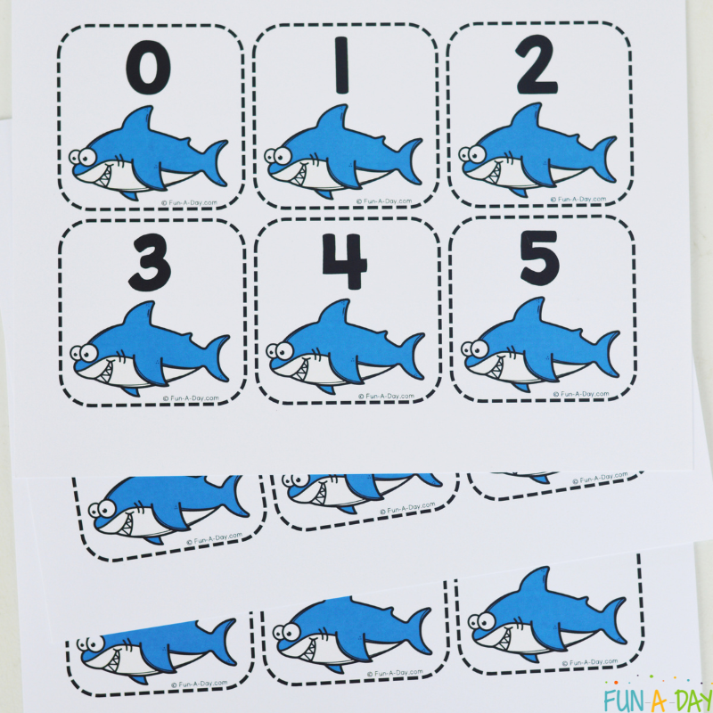 pile of uncut printable shark calendar numbers
