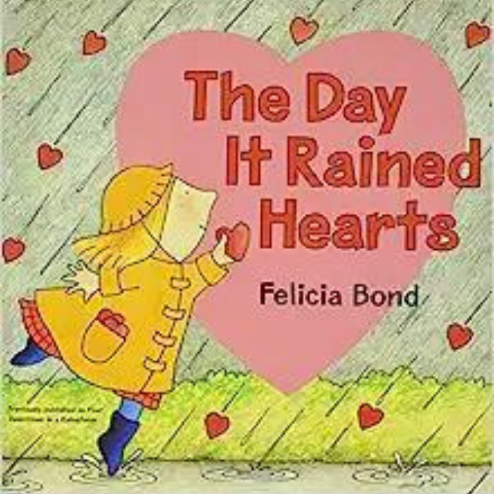 The Day it Rained Hearts cover art. Illustration of young girl in a yellow rain jacket catching hearts falling from the sky.