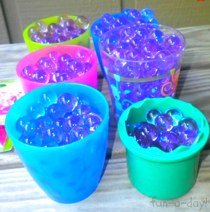 6 cups filled with purple water beads