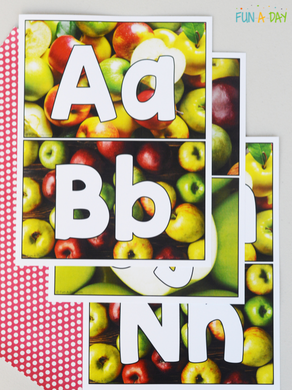 staggered pile of apple ABCs printable mats
