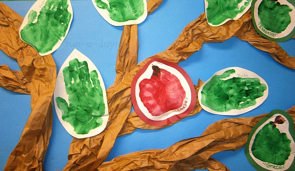 crumpled brown paper tree with handprint apples and leaves on apple bulletin board