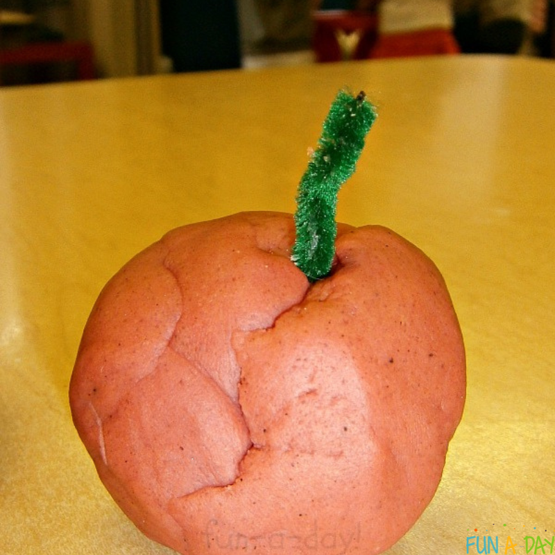 apple made with playdough and green pipe cleaner