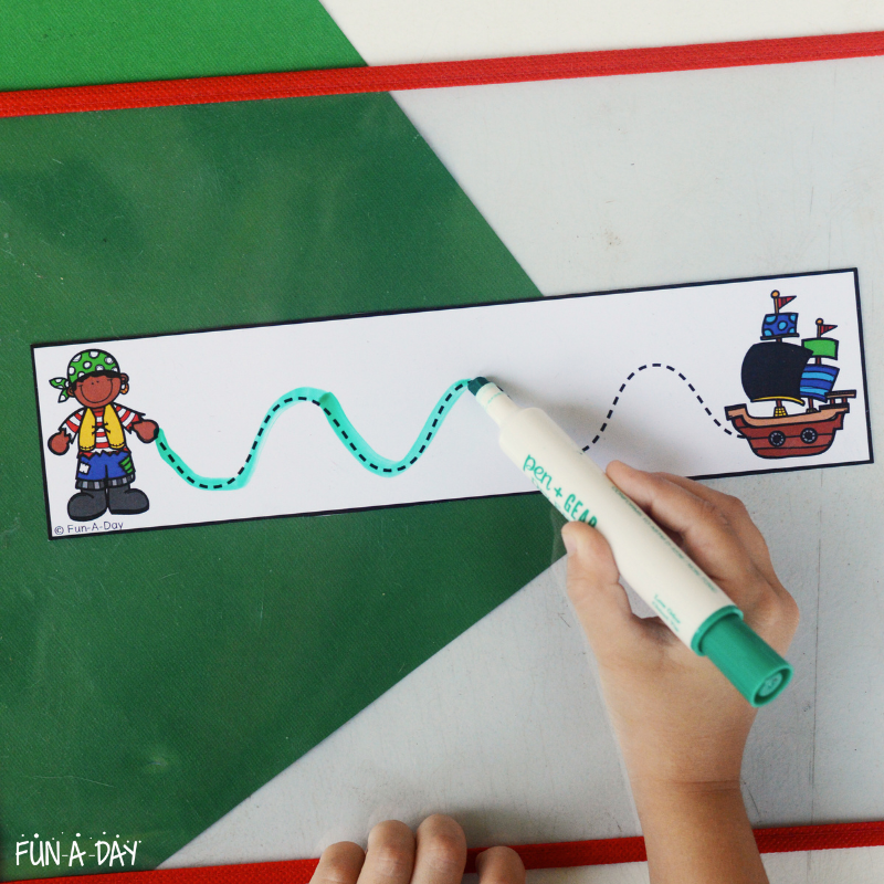 child using dry erase marker on pirate tracing sheets