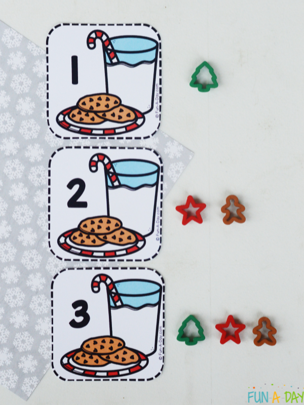 Cookies and milk calendar numbers with the correlating amount of mini cookie cutters placed next to each card.