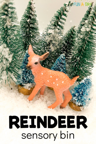 reindeer toy in sensory snow with fake trees and text that reads reindeer sensory bin