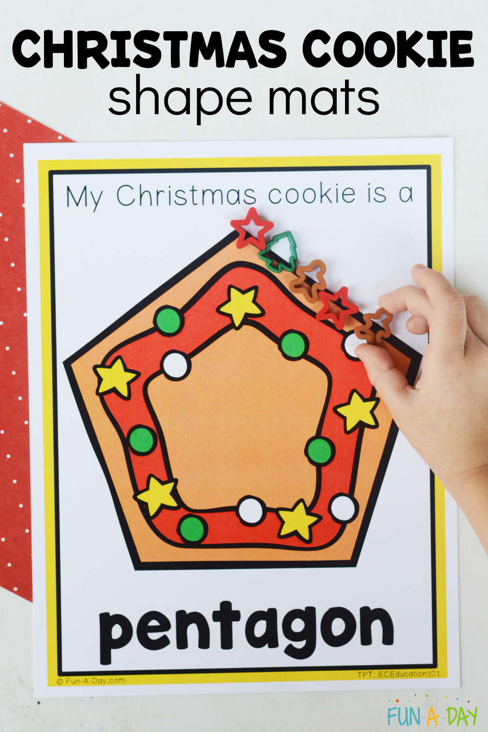 child placing small manipulatives around a pentagon shape with text that reads christmas cookie shape mats