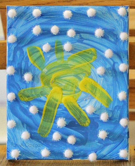 canvas made by preschoolers with blue sky, yellow sun, and white pompom clouds