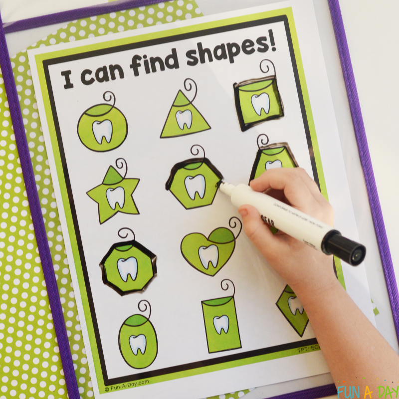 preschooler tracing shapes on dental shape mats printable