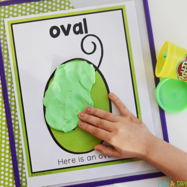 preschooler using playdough to make oval on dental shape playdough mats