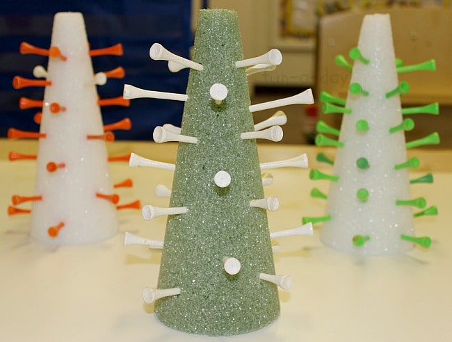 white and green foam trees with golf tees in them to make geoboard christmas trees