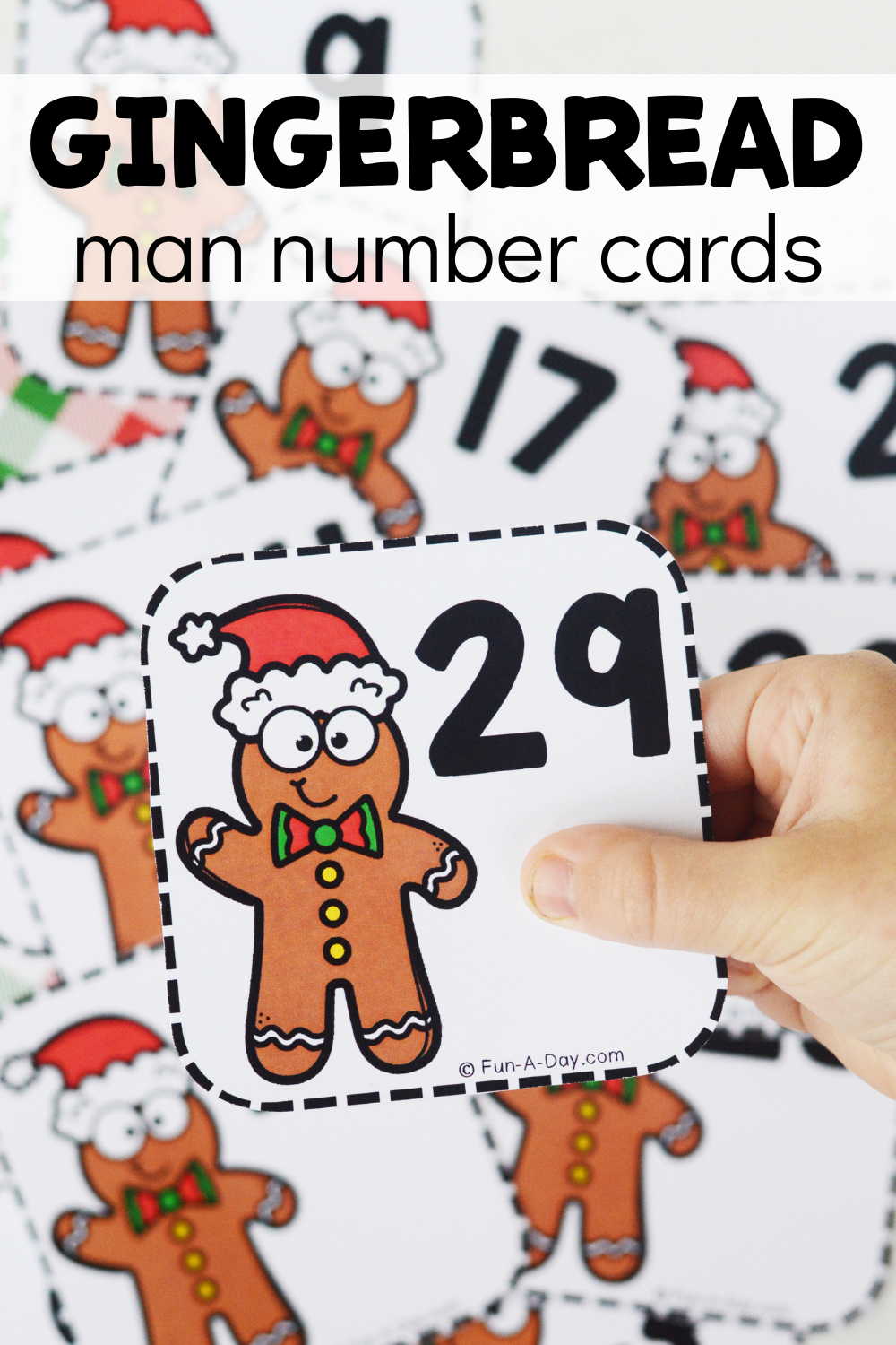 preschooler holding number card above a pile of more, with text that reads gingerbread man number cards