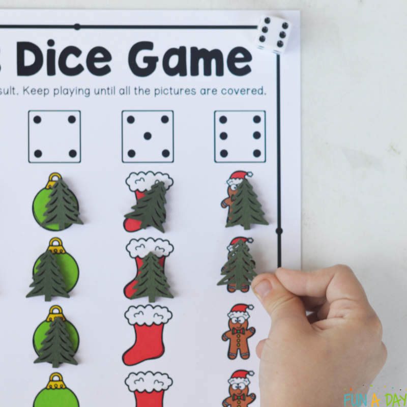preschooler playing christmas dice game