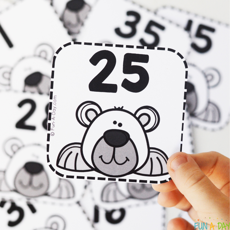 child holding number 25 over more polar bear calendar numbers
