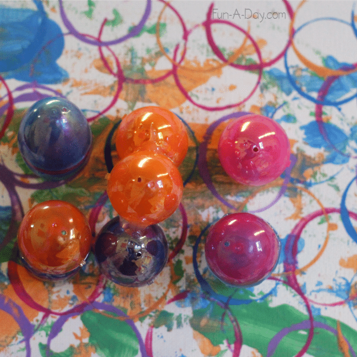 close up of plastic easter eggs on egg stamped canvas made by preschoolers