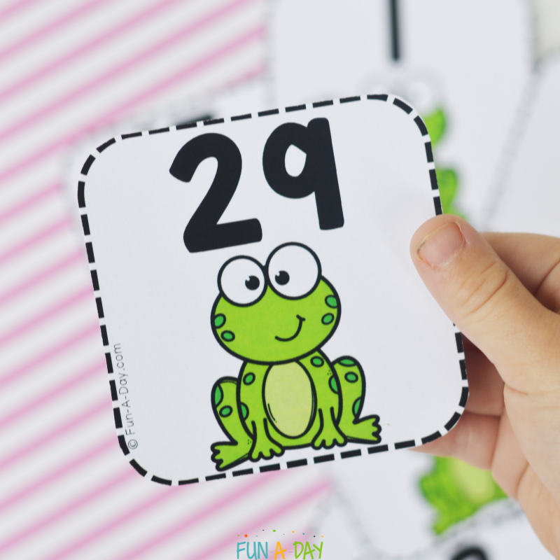 preschooler holding frog calendar number 29