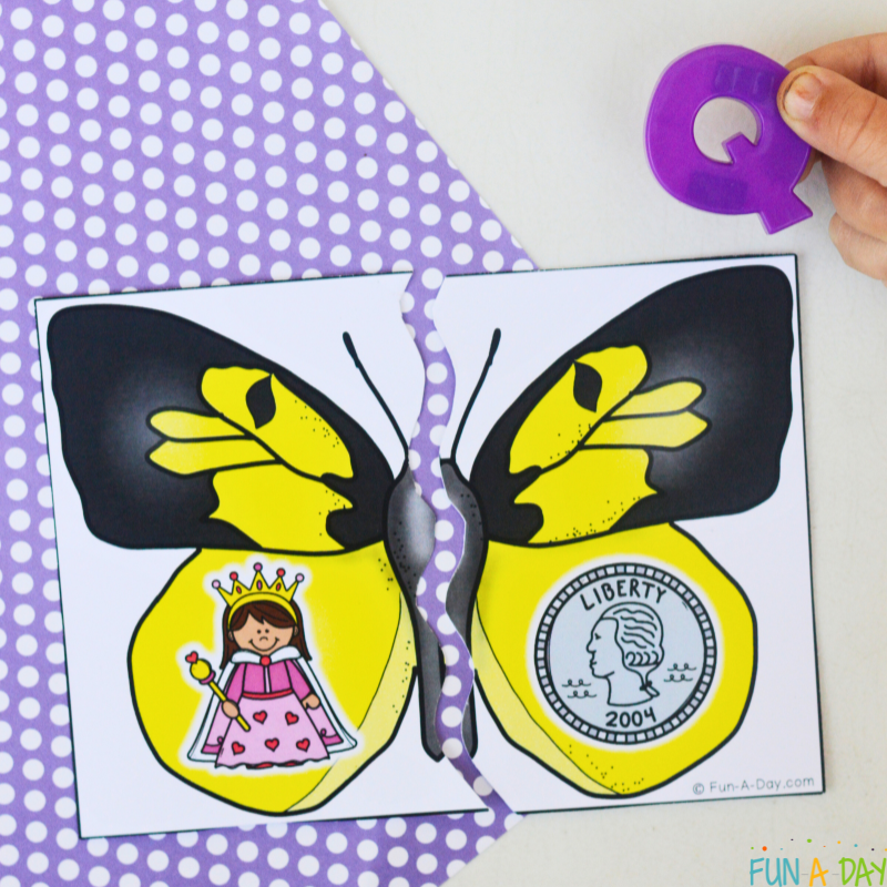 Matching the letter Q to the assembled queen and quarter butterfly puzzle