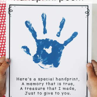 child holding printable poem with blue hand print and text that reads father's day handprint poem